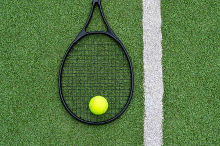 Top view of tennis rackets and ball of green grass. Horizontal sport poster, greeting cards, headers, websiteの写真素材