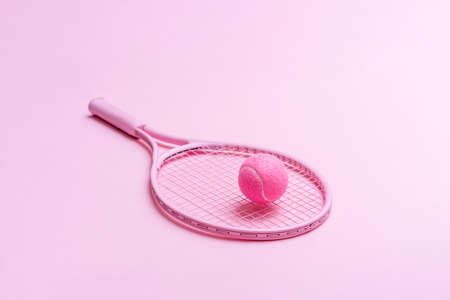 Pink tennis racket and pink ball on pink background. Horizontal sport theme poster, greeting cards, headers, website and appの写真素材