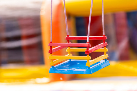 Empty kids swing in public park. Horizontal kid game theme poster, greeting cards, headers, website and appの写真素材