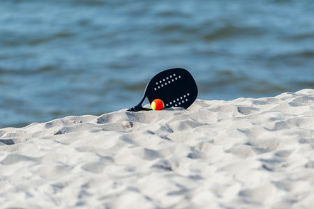 Racket and ball on the sandy beach. Summer sport concept. Horizontal sport theme poster, greeting cards, headers, website and appの写真素材