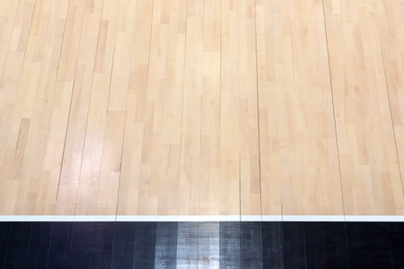 Wooden floor volleyball, basketball, badminton, futsal, handball court with light effect. Wooden floor of sports hall with marking lines line on wooden floor indoor, gym courtの写真素材
