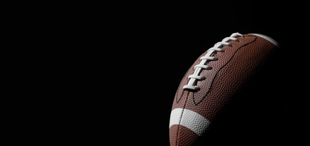 American football ball close up on black background. Horizontal sport theme poster, greeting cards, headers, website and appの写真素材