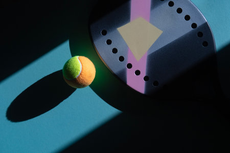 Professional beach tennis racket and ball on blue background. Horizontal sport theme poster, greeting cards, headers, website and appの写真素材