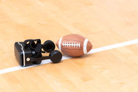 Interactive glasses and American football ball in a physical education lesson. Horizontal interactive sport theme poster, greeting cards, headers, website and appの写真素材