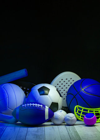 Sports equipment, rackets and balls on hardwood court floor with neon light background. Vertical education and sport poster, greeting cards, headers, websiteの写真素材