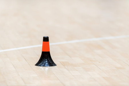 Training cones on hardwood court floor. Basketball, futsal, handball and volleyball practice. Game...