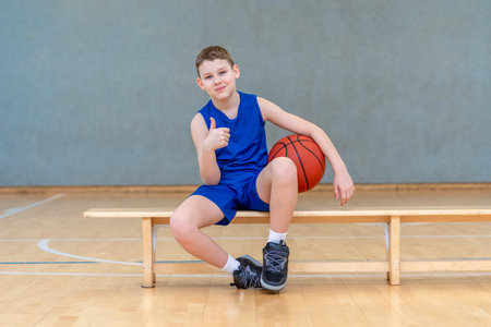 School kid playing basketball in a physical education lesson. Horizontal sport theme poster, greeting cards, headers, website and appの写真素材