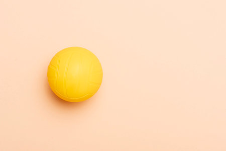 Spike ball game yellow ball on camel color background. Horizontal sport theme poster, greeting cards, headers, website and appの写真素材