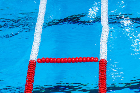 The view of an empty public swimming pool indoors. Lanes of a competition swimming pool. Horizontal...