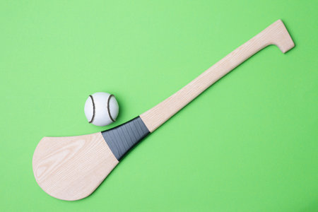 Hurling bat and sloitar on green background. Horizontal sport theme poster, greeting cards, headers, website and appの写真素材