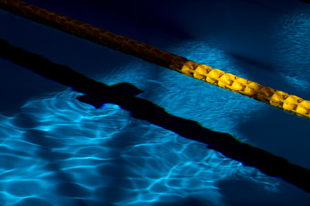 The view of an empty public swimming pool indoors. Lanes of a competition swimming pool. Horizontal sport theme poster, greeting cards, headers, website and appの写真素材