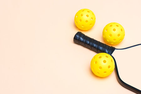 Beige pickleball racket and ball on beige background. Horizontal education and sport poster, greeting cards, headers, websiteの写真素材