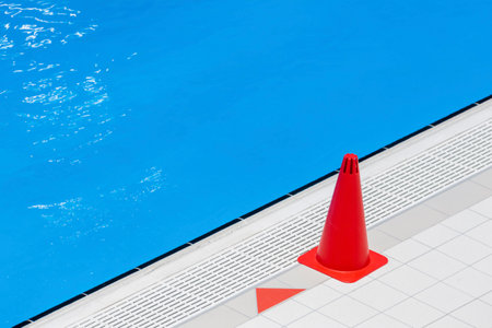Red training cones on swimming pool floor. Trainning and camp concept. Horizontal sport theme poster, greeting cards, headers, website and appの写真素材