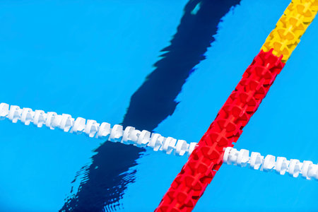 The view of an empty public swimming pool indoors. Lanes of a competition swimming pool. Horizontal sport theme poster, greeting cards, headers, website and appの写真素材