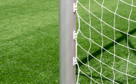 Hockey field, soccer, american football, lacrosse net background over green grass and blurry stadium. Horizontal sport poster, greeting cards, headers, websiteの写真素材