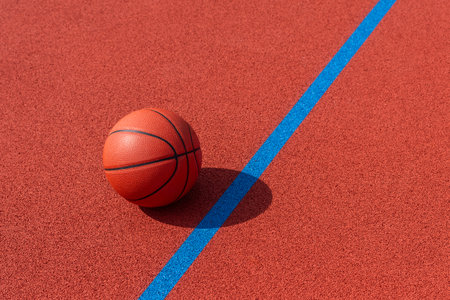 New orange basketball with blue line on orange court of gymnasium sport floor. Horizontal sport theme poster, greeting cards, headers, website and appの写真素材