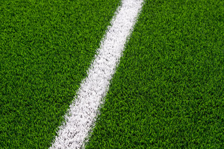 Green synthetic grass sports field with white line shot from above. Soccer, hurling, lacrosse, rugby, football, baseball sport conceptの写真素材