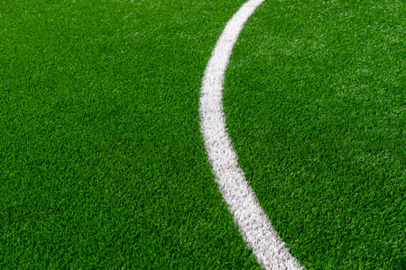 Green synthetic grass sports field with white line shot from above. Soccer, hurling, lacrosse, rugby, football, baseball sport conceptの写真素材
