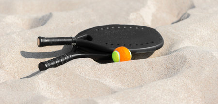 Racket and ball on the sandy beach. Summer sport concept. Horizontal sport theme poster, greeting cards, headers, website and appの写真素材