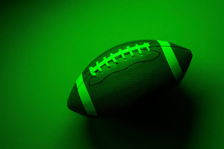 American football ball close up on green background. Horizontal sport theme poster, greeting cards,...