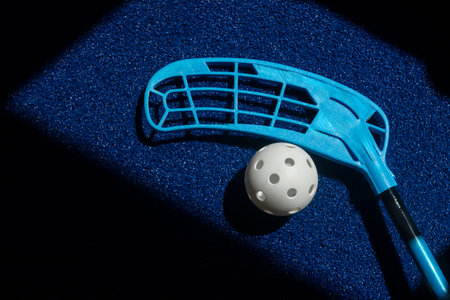 Floorball stick and white ball on blue background. Horizontal sport theme poster, greeting cards, headers, website and appの写真素材