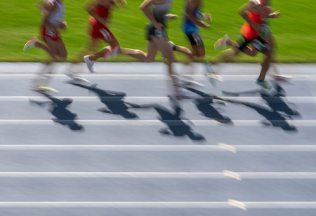 Group professional runners in stadium. Motion blur effect. Horizontal sport theme poster, greeting cards, headers, website and appの写真素材