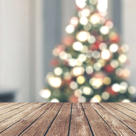 Wood table top on blur Christmas tree in living roomの写真素材