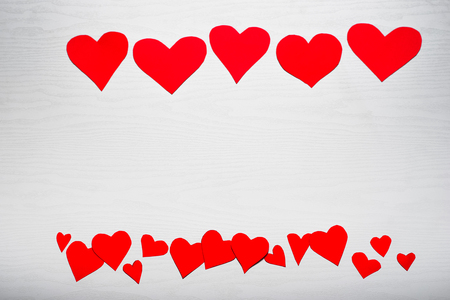 Wooden white background with red hearts. The concept of Valentine Day.の写真素材