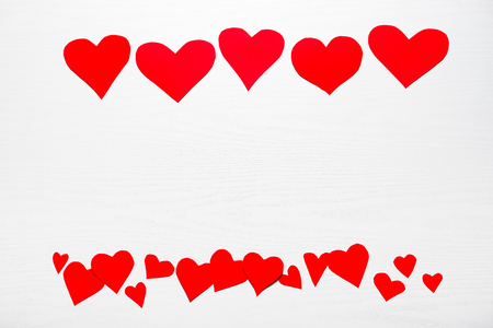 Wooden white background with red hearts. The concept of Valentine Day.の写真素材