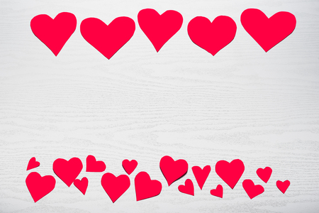 Wooden white background with red hearts. The concept of Valentine Day.の写真素材