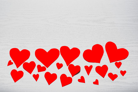 Wooden white background with red hearts. The concept of Valentine Day.の写真素材