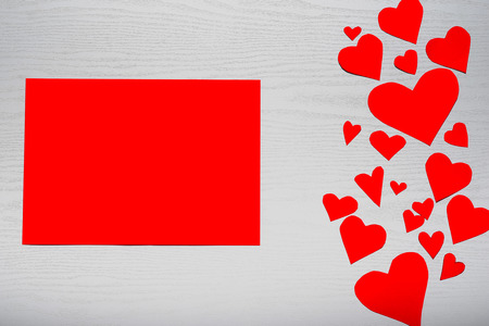 Wooden white background with red hearts and red leaf paper. The concept of Valentine's Day.の写真素材