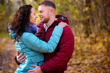 Portrait of young loving couple kissing in autumn parkの写真素材