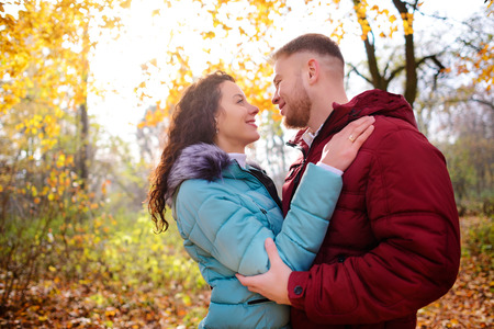 Portrait of young loving couple kissing in autumn parkの写真素材