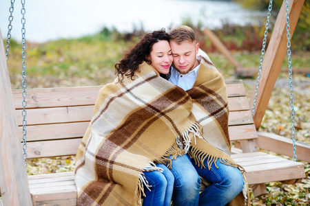 Amorous couple on romantic date on swings outdoor ,autumnの写真素材