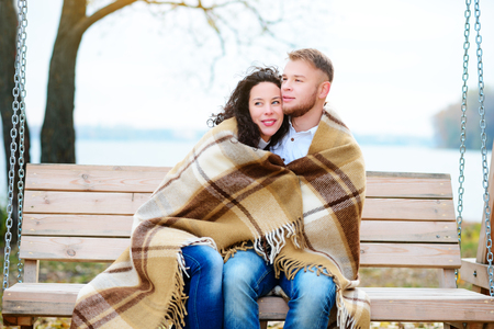 Amorous couple on romantic date on swings outdoor ,autumnの写真素材