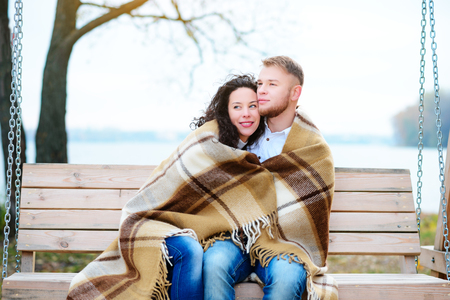 Amorous couple on romantic date on swings outdoor ,autumnの写真素材