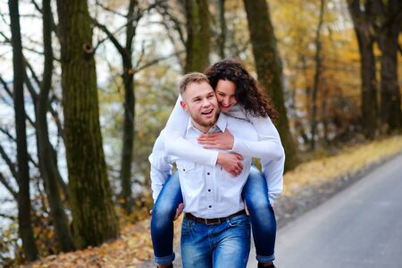 Lovers walking hand in hand in autumn parkの写真素材