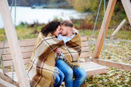Amorous couple on romantic date on swings outdoor ,autumnの写真素材