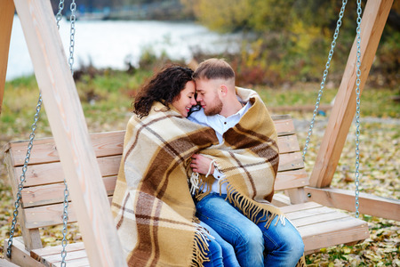 Amorous couple on romantic date on swings outdoor ,autumnの写真素材