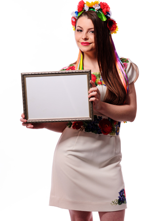 Smiling woman holding white sign board. Casual dressed girl with advertising banner.の写真素材