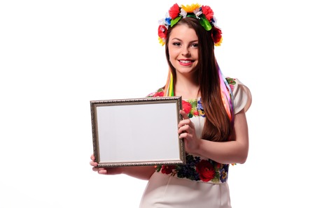 Smiling woman holding white sign board. Casual dressed girl with advertising banner.の写真素材