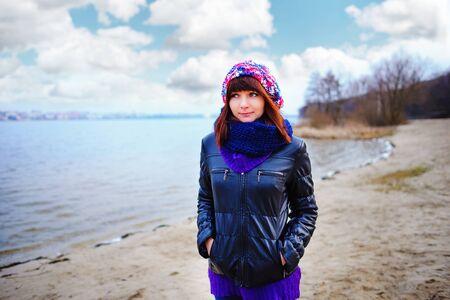 pretty girl posing near mountain lake. autumn lanscape in forest.の写真素材