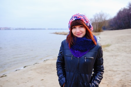 pretty girl posing near mountain lake. autumn lanscape in forest.の写真素材