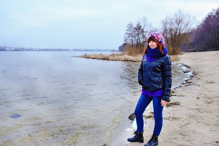 pretty girl posing near mountain lake. autumn lanscape in forest.の写真素材