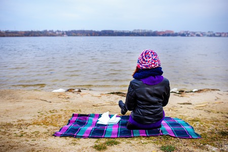 A woman on the old beach starring at the restless Seaの写真素材