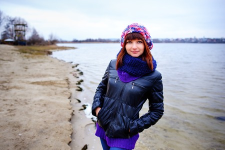 pretty girl posing near mountain lake. autumn lanscape in forest.の写真素材