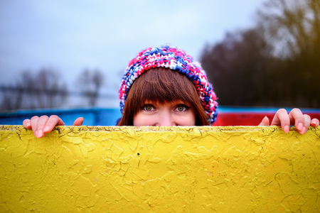 A young woman holding a yellow boardの写真素材