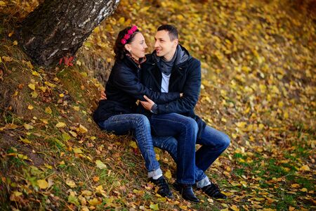 Parents look at children in autumn park, A lovely sunny dayの写真素材