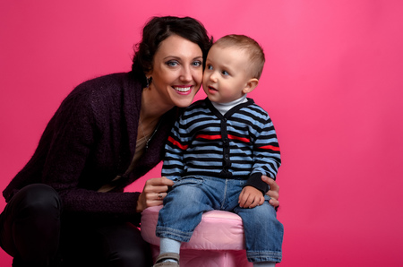 Portrait of baby and his mother on a pink background, Studioの写真素材